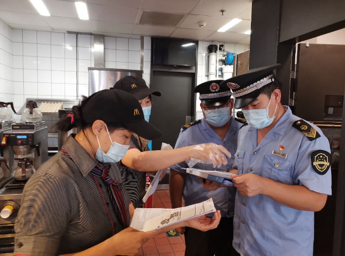 順義區市場監管局執法人員檢查考點學校食品安全情況。