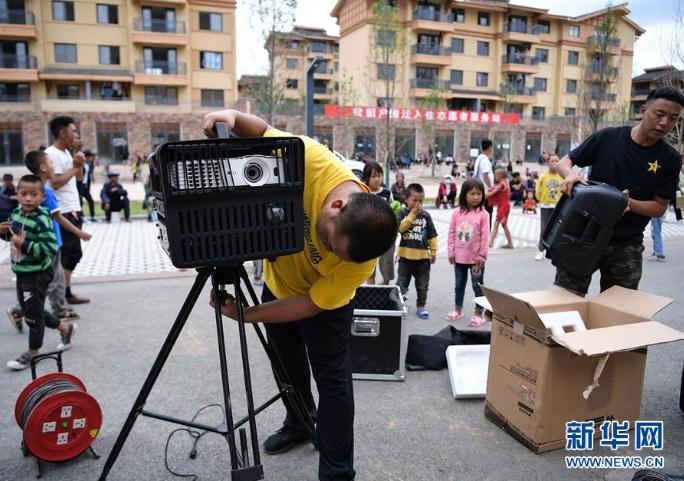 搬下山的人們，住進了有彝族傳統(tǒng)建筑風(fēng)格的新社區(qū)，每隔一段時間就會有縣里的放映隊為這里的群眾放露天電影（8月11日攝）。 新華社記者 李賀 攝