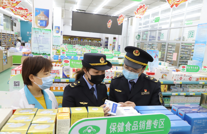 圖為沂南縣市場監管局執法人員在一家藥店保健食品專區檢查。