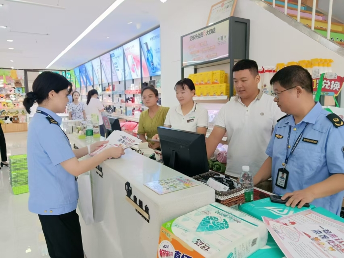 圖為執法人員在一家商場發放宣傳材料。